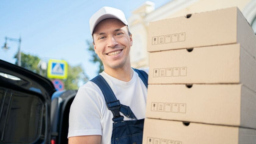 The courier is an employee in the courier company delivering the order in boxes.